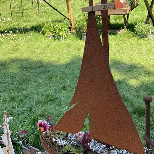 Metallkunst als Segelschiff mit Pflanzen vor grüner Wiese beim Kunsthandwerkermarkt im Westfalenpark, Dortmund