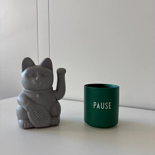 img 2025 09 13 150117 Graue Winkekatze neben grünem Becher mit Aufschrift „PAUSE“